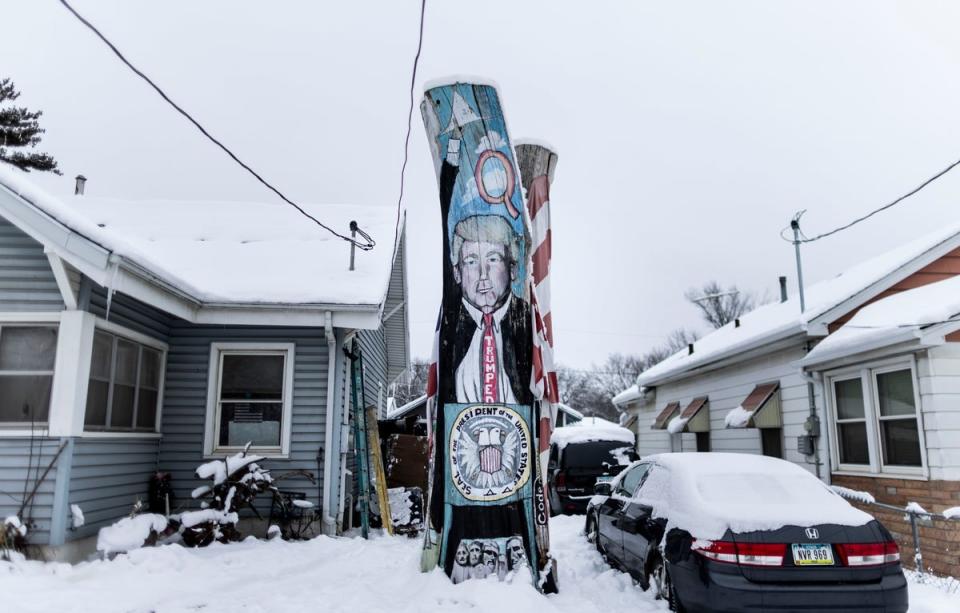 The remains of a tree painted with an image of former President Donald Trump in Des Moines, Iowa, USA, 11 January 2024 (EPA)