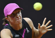 Poland's Iga Swiatek plays Britain's Emma Raducanu during her quarterfinals tennis match at the WTA Tour in Stuttgart, Germany, Friday April 19, 2024. (Marijan Murat/dpa via AP)