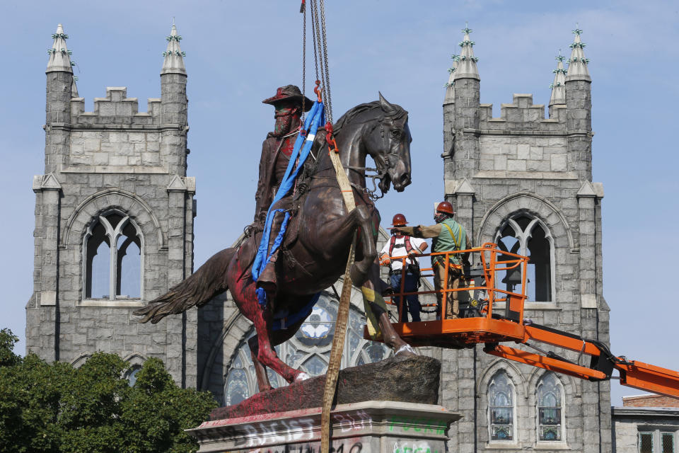 FILE - Crews prepare to remove a statue Confederate General J.E.B. Stuart on Monument Avenue in Richmond, Va. on July 7, 2020. At least 63 Confederate statues, monuments or markers have been removed from public land across the country since George Floyd’s death on May 25, making 2020 one of the busiest years yet for removals, according to an Associated Press tally. (AP Photo/Steve Helber, File)