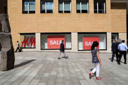 People walk past a Sale sign in Beirut, Lebanon September 28, 2018. REUTERS/Jamal Saidi