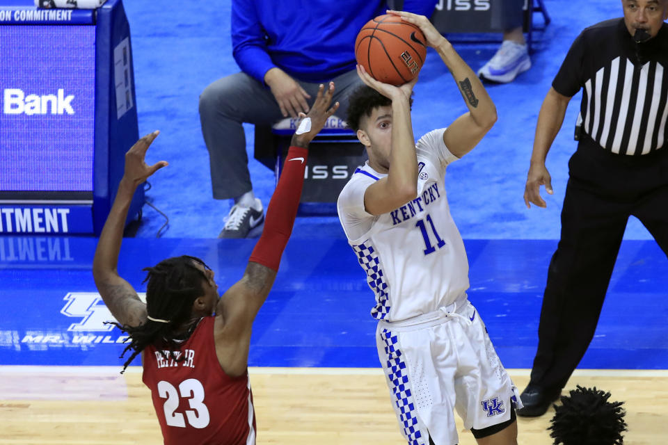 Kentucky's Dontaie Allen (11) shoots while defended by Alabama's John Petty Jr. during the second half of an NCAA college basketball game in Lexington, Ky., Tuesday, Jan. 12, 2021. (AP Photo/James Crisp)