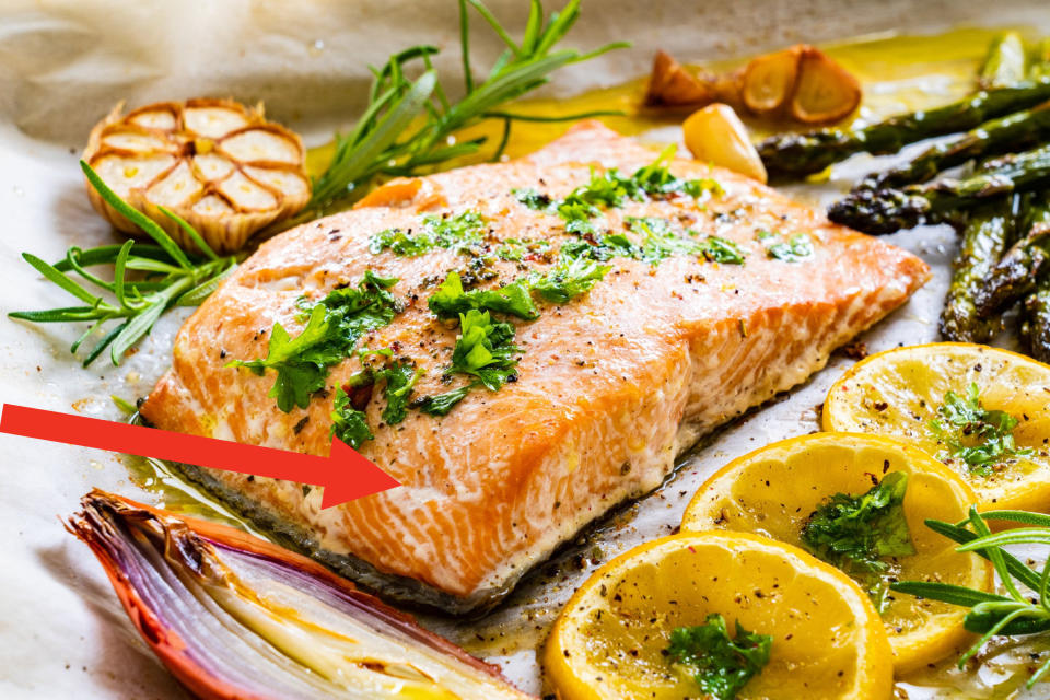 Cooked salmon with herbs and lemon.