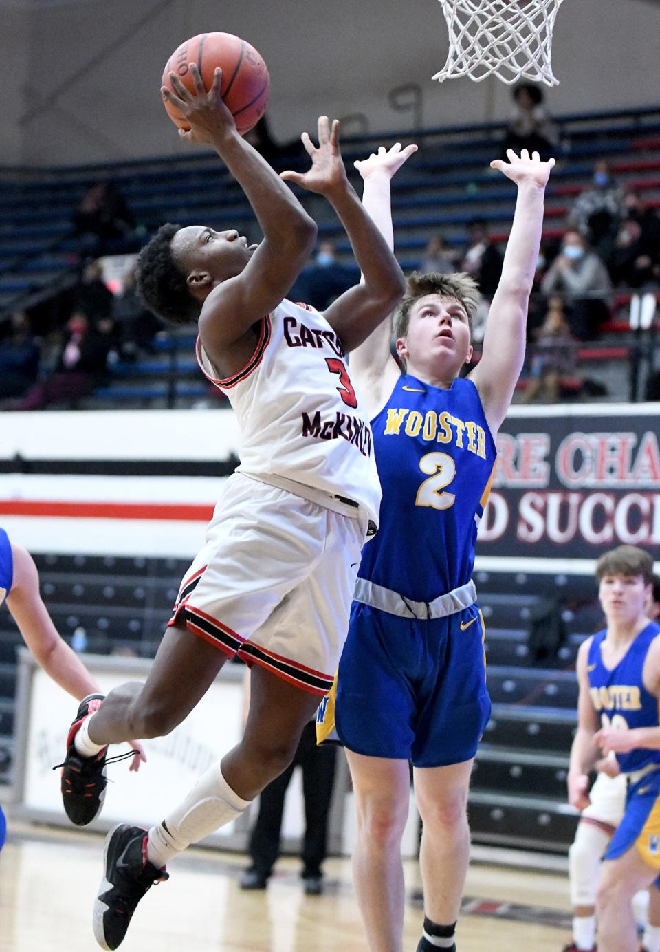 Jahlil Graham of McKinley goes up for two guarded by Ethan Hann of Wooster at McKinley Tuesday, February 16, 2021. 