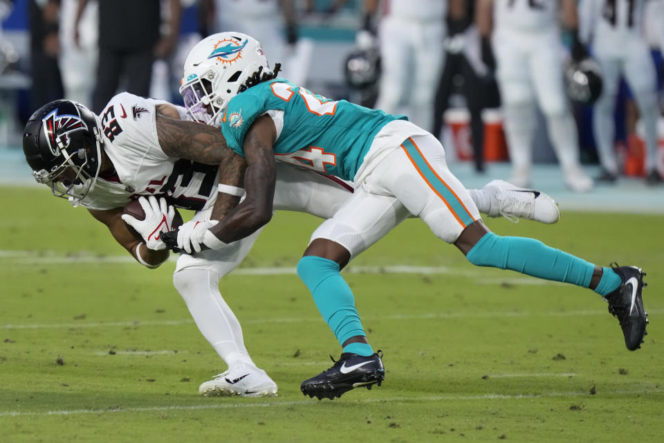 Atlanta Falcons wide receiver J.J. Arcega-Whiteside (83) is stopped by Miami Dolphins cornerback Cam Smith (24) after a catch in the first half of a preseason an NFL football game, Friday, Aug. 11, 2023, in Miami Gardens, Fla. (AP Photo/Wilfredo Lee)