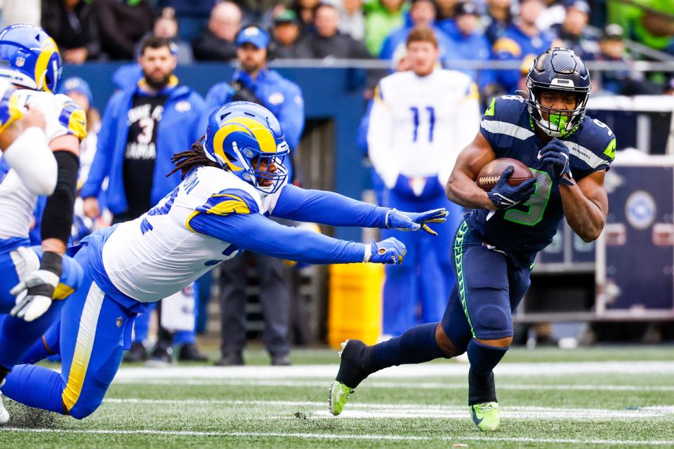 Seattle Seahawks running back Kenneth Walker III (9) escapes a tackle attempt by Los Angeles Rams defensive tackle Larrell Murchison.
