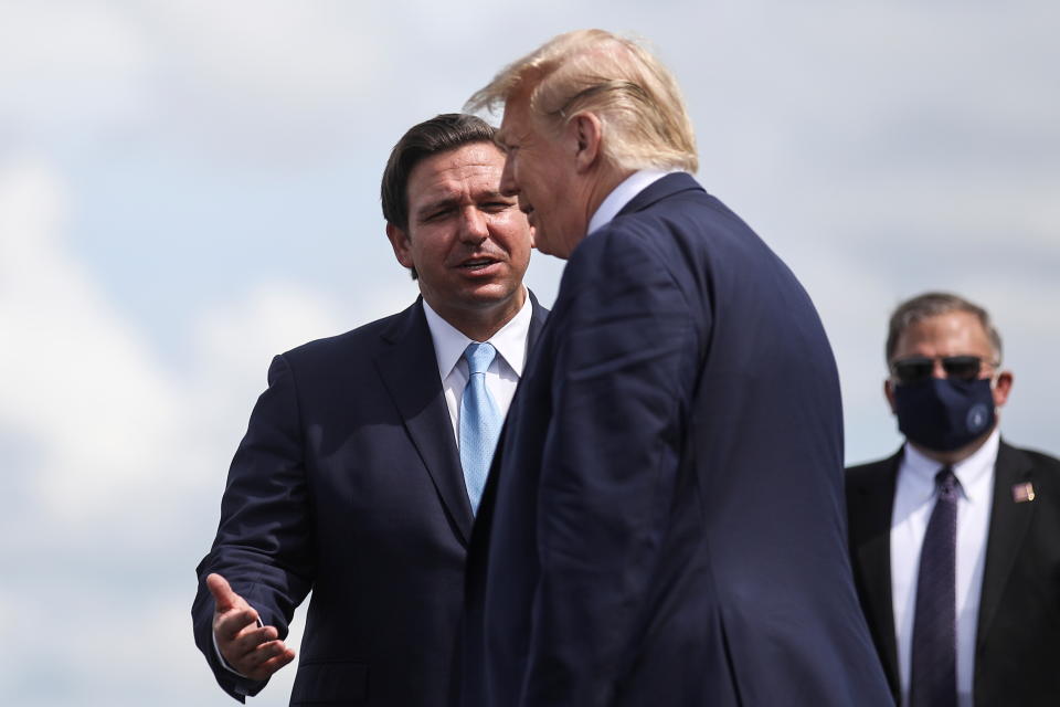 Then-President Donald Trump is greeted by Florida Governor Ron Desantis at the airport in October 2020.