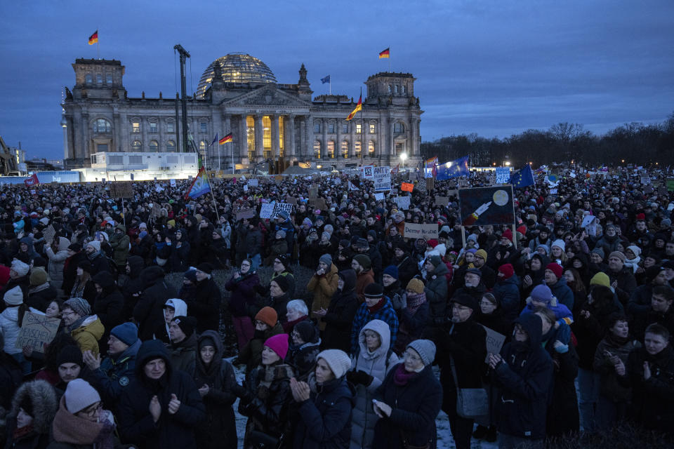 People gather to protest against the AfD party and right-wing extremism in front of the Reichstag building in Berlin, Germany, Sunday, Jan. 21, 2024. (AP Photo/Ebrahim Noroozi)