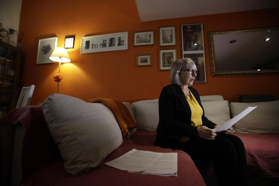 In this picture taken on Friday, Jan. 31, 2020 Yolanda Martinez Garcia reads a letter of her son during an interview with the Associated Press at her home, in Milan, Italy. Her son was sexually abused by one of the priests of the Legion of Christ, a disgraced religious order. (AP Photo/Luca Bruno)