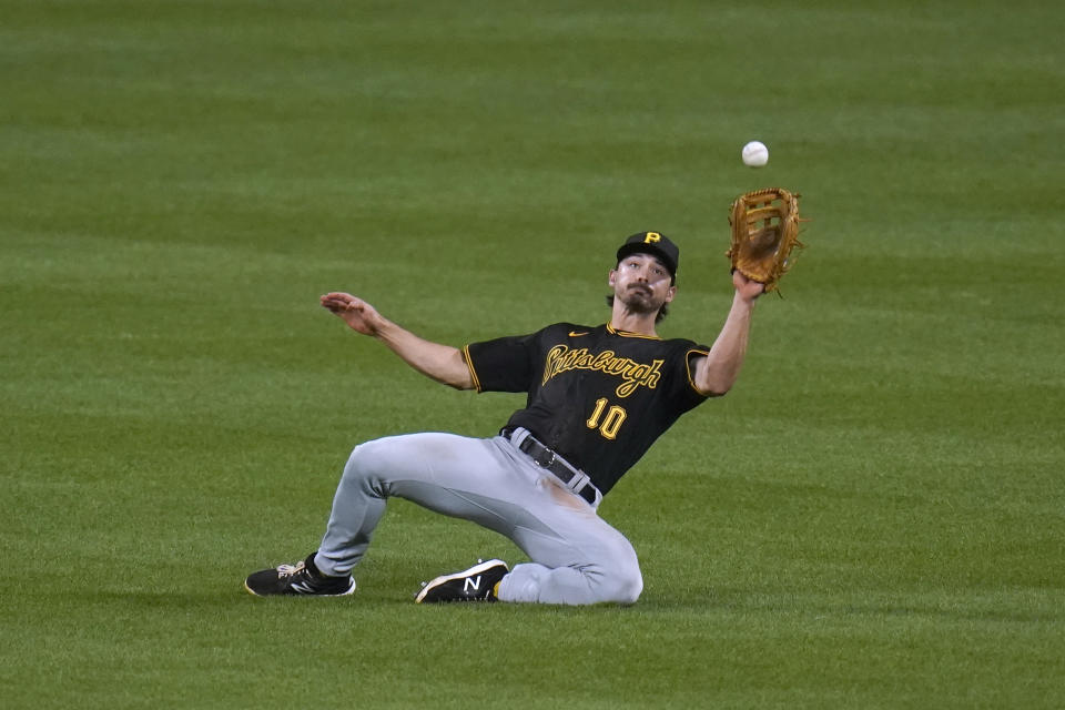 Pittsburgh Pirates center fielder Bryan Reynolds slides to catch a fly ball by St. Louis Cardinals' Harrison Bader for an out during the seventh inning of a baseball game Tuesday, May 18, 2021, in St. Louis. (AP Photo/Jeff Roberson)