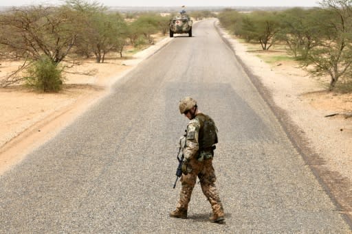 A German soldier in northern Mali with the UN mission MINUSMA checks the road for bombs