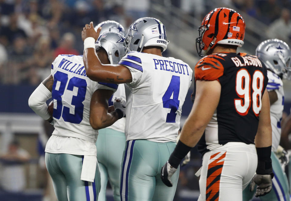 Dallas Cowboys quarterback Dak Prescott (4) and wide receiver Terrance Williams (83) celebrate after they connected on a pass for a touchdown against the Cincinnati Bengals during the first half of a preseason NFL football game in Arlington, Texas, Saturday, Aug. 18, 2018. (AP Photo/Michael Ainsworth)