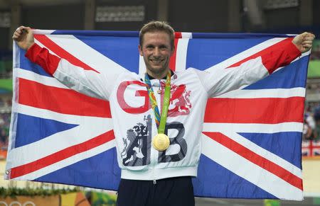 Jason Kenny (GBR) of Britain with the gold medal on the podium. REUTERS/Matthew Childs