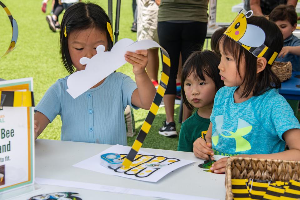 Children make bee headbands at the Books and Bees Festival.