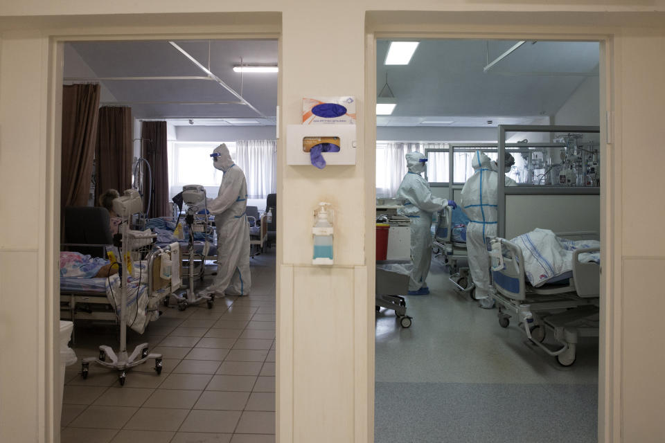 FILE - In this Aug. 26, 2021, file, photo, medical professionals treat patients in the coronavirus ward at Barzilai Medical Center in Ashkelon, Israel. Israeli health officials say the booster shot, which has already been delivered to about a third of the population, is helping to suppress the country’s latest wave of COVID-19 infections. (AP Photo/Maya Alleruzzo, File)