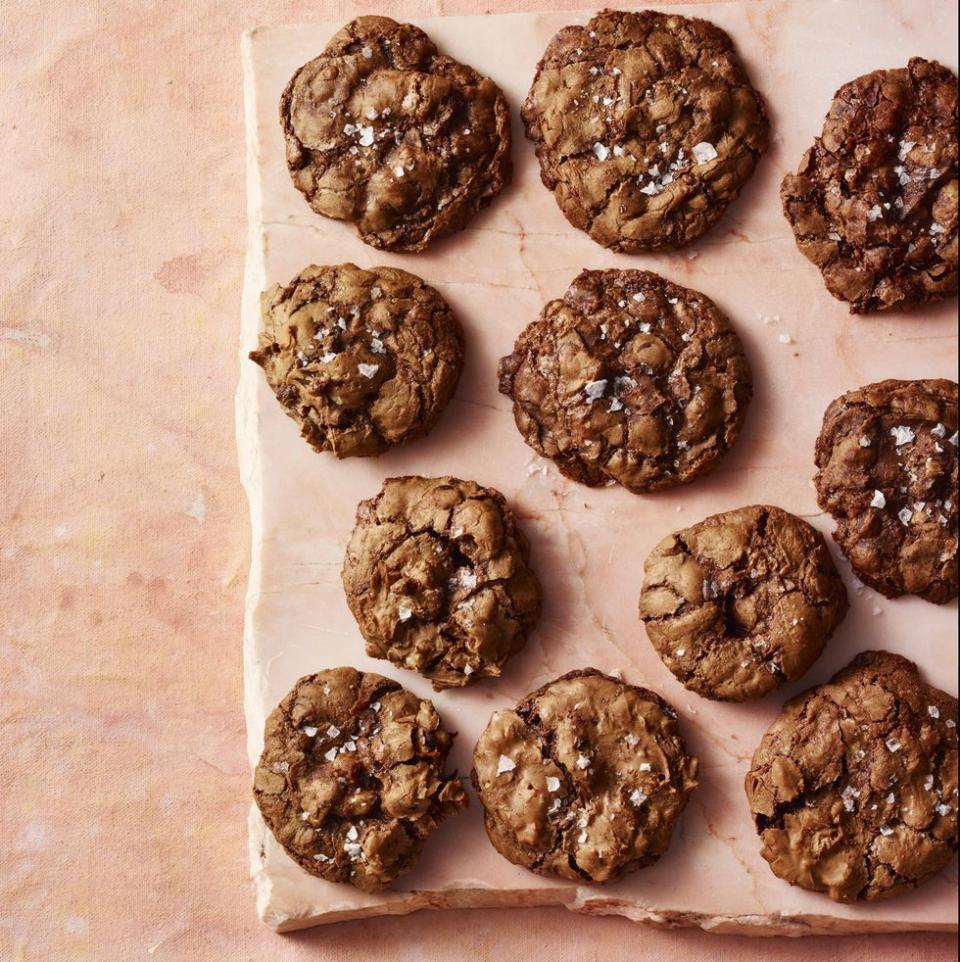 a close up of chewy chocolate walnut cookies