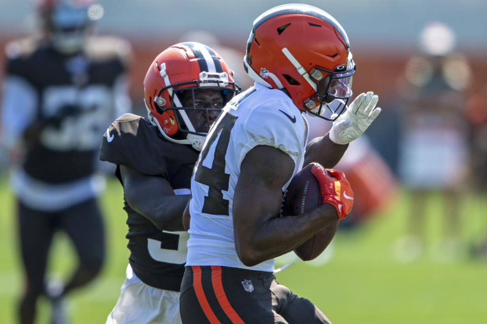 Cleveland Browns defensive back Emmanuel Rugamba, back, breaks up a pass intended for receiver Ja'Marcus Bradley during an NFL football practice in Berea, Ohio, Wednesday, Aug. 4, 2021. (AP Photo/David Dermer)