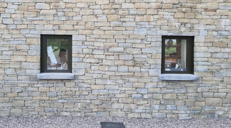 Used items stacked in windows greet guests on first entering the hotel (Benjamin Salmon)