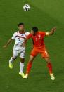 Costa Rica's Giancarlo Gonzalez jumps for the ball with Robin van Persie of the Netherlands during their 2014 World Cup quarter-finals at the Fonte Nova arena in Salvador July 5, 2014. REUTERS/Ruben Sprich