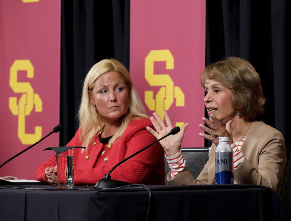 Jennifer Cohen, left, looks on as Southern California president Carol L. Folt, right, talks during a news conference announcing her as athletic director at the university in Los Angeles, Monday, Aug. 21, 2023. (AP Photo/Richard Vogel)