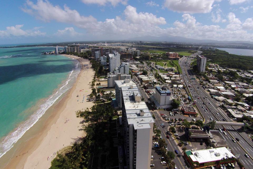An aerial view of the Isla Verde Beach tourist zone, left, and the Roman Baldorioty de Castro Highway, right, in Carolina, Puerto Rico, Tuesday, Jan. 13, 2015.