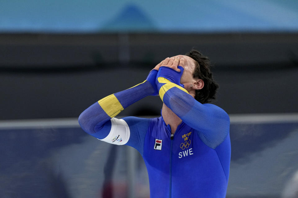 Nils van der Poel of Sweden celebrates after winning the gold medal and setting an Olympic record in the men's speedskating 5,000-meter race at the 2022 Winter Olympics, Sunday, Feb. 6, 2022, in Beijing. (AP Photo/Ashley Landis)