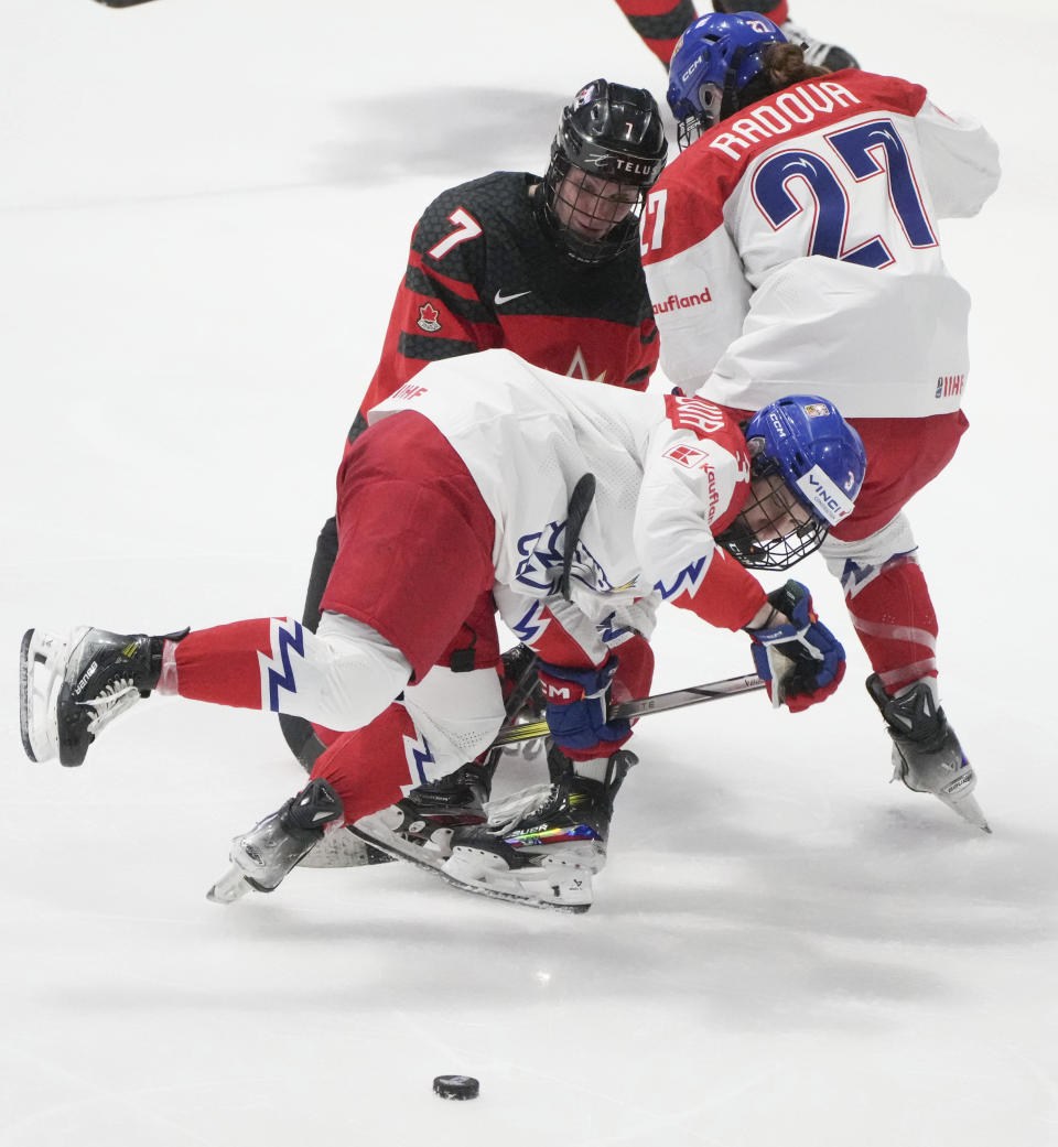 Canada's Laura Stacey (7) hooks Czechia's Adela Sapovalivova (3) during the third period of a hockey match at the IIHF Women's World Championships in Utica, N.Y., Sunday, April 7, 2024. (Christinne Muschi/The Canadian Press via AP)