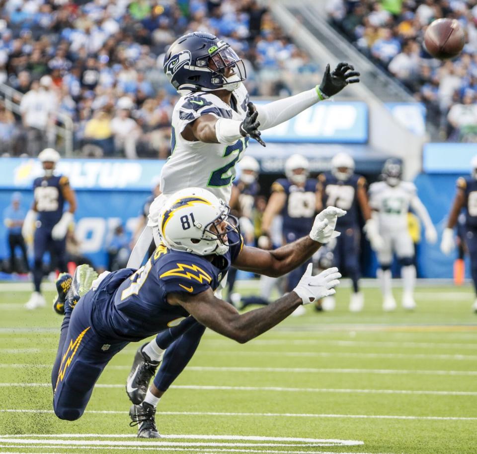 Seahawks cornerback Tariq Woolen defends against a pass intended for the Chargers' Mike Williams (81).