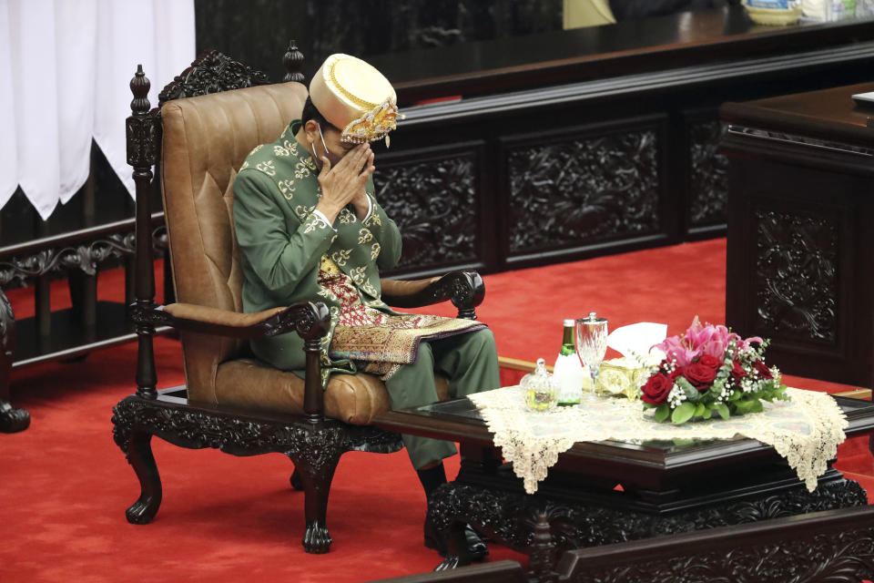 Indonesian President Joko Widodo prays after delivering his annual State of the Nation Address ahead of the country's Independence Day, at the parliament building in Jakarta, Indonesia, Tuesday, Aug. 16, 2022. (Bagus Indahono/Pool Photo via AP)