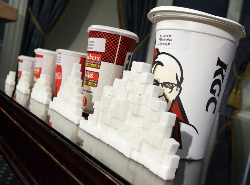 Various size cups and sugar cubes  are displayed at a news conference at New York's City Hall, Thursday, May 31, 2012. New York Mayor Michael Bloomberg is proposing a ban on the sale of large sodas and other sugary drinks in the city's restaurants, delis and movie theaters in the hopes of combating obesity, an expansion of his administration's efforts to encourage healthy behavior by limiting residents' choices. (AP Photo/Richard Drew)