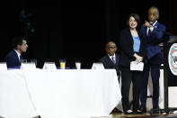 Democratic presidential candidate Sen. Amy Klobuchar, D-Minn., stands with Rev. Al Sharpton, right, after speaking as Democratic presidential candidate former South Bend, Ind., Mayor Pete Buttigieg, left, looks on at the National Action Network South Carolina Ministers' Breakfast, Wednesday, Feb. 26, 2020, in North Charleston, S.C. Second from left is Rev. Nelson Rivers. (AP Photo/Matt Rourke)