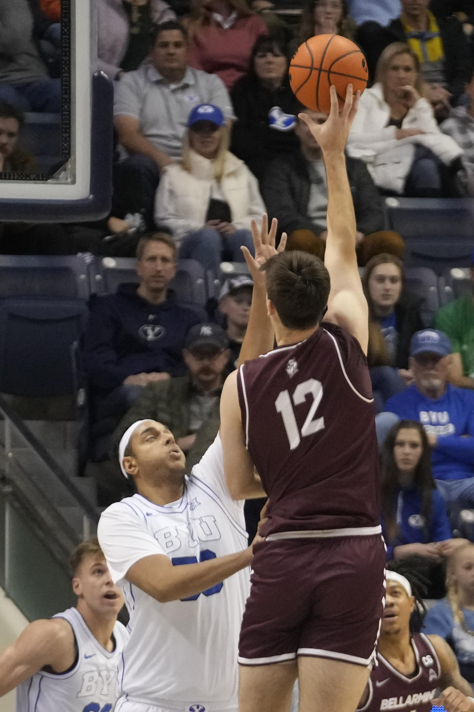 Bellarmine forward Langdon Hatton (12) shoots as BYU center Aly Khalifa, second from left, defends during the first half of an NCAA college basketball game Friday, Dec. 22, 2023, in Provo, Utah. (AP Photo/Rick Bowmer)