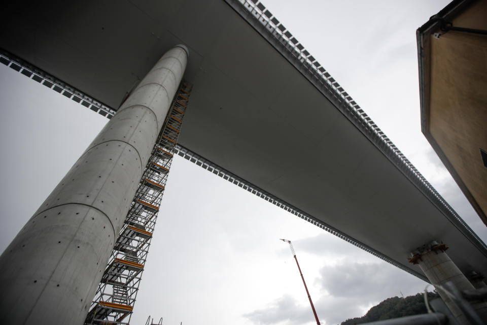 A view of the new San Giorgio Bridge ahead of its inauguration in Genoa, Italy, Monday, Aug. 3, 2020. A large section of the old Morandi bridge collapsed on Aug. 14, 2018, killing 43 people and forcing the evacuation of nearby residents from the densely built-up area. (AP Photo/Luca Bruno)