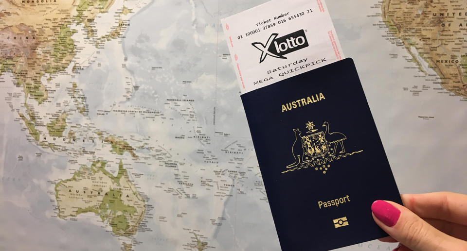 A woman holds a passport with a lotto ticket inside. 