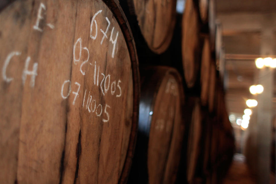 In this April 5, 2013 photo, oak barrels loaded with cachaca, Brazil's national spirit, sit at the Alambique Cambeba, in Alexania, Goias state, Brazil. Cachaca is made from fresh-pressed sugarcane juice, extracted using a large roller press. The juice is filtered and then fermented in tanks. (AP Photo/Eraldo Peres)