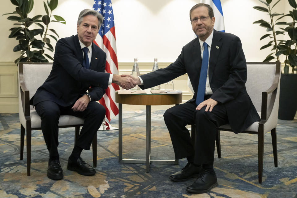 Israel's President Isaac Herzog, right and US Secretary of State Antony Blinken shake hands, during a meeting in Tel Aviv, Israel, Thursday, Nov. 30, 2023, following the announcement of an extension of the truce between Israel and Hamas just before it was due to expire. (Saul Loeb/Pool Photo via AP)