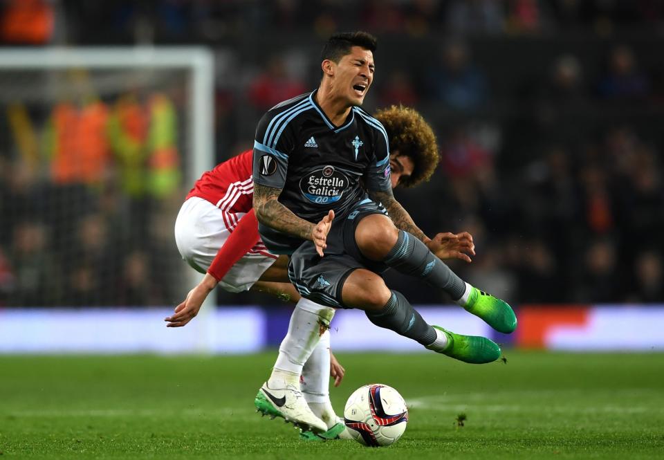 <p>Pablo Hernandez of Celta Vigo is tackled by Marouane Fellaini of Manchester United during the UEFA Europa League, semi final second leg match, between Manchester United and Celta Vigo at Old Trafford </p>