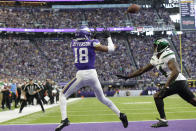 Minnesota Vikings wide receiver Justin Jefferson (18) catches a 10-yard touchdown pass ahead of New York Jets cornerback D.J. Reed (4) during the second half of an NFL football game, Sunday, Dec. 4, 2022, in Minneapolis. (AP Photo/Andy Clayton-King)