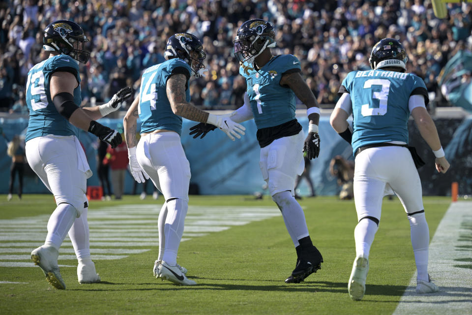 Jacksonville Jaguars running back Travis Etienne Jr. (1) celebrates after a touchdown against the Carolina Panthers during the second half of an NFL football game Sunday, Dec. 31, 2023, in Jacksonville, Fla. (AP Photo/Phelan M. Ebenhack)