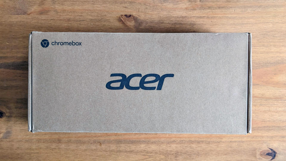 An Acer Chromebox CXI4 mini PC sitting on a wooden desk