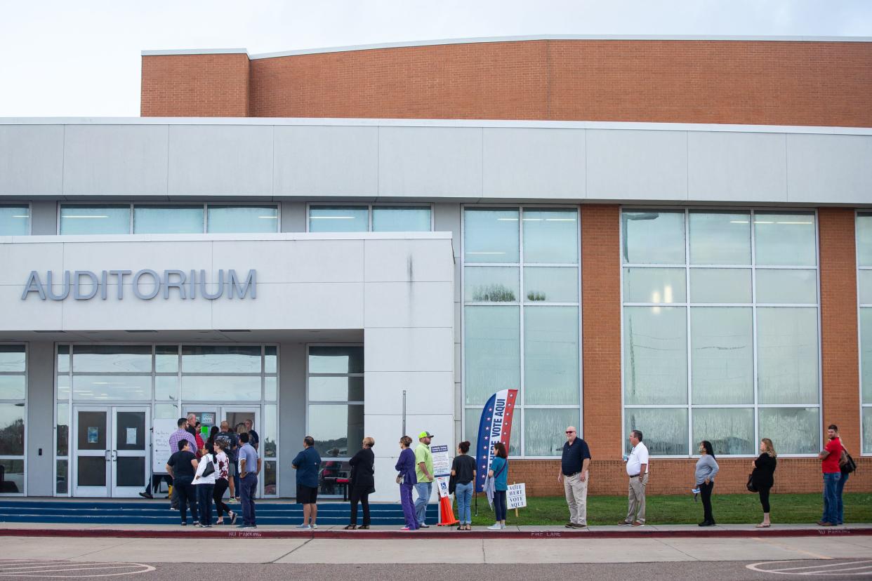 Early morning voters line up outside of a polling station at Veterans Memorial High School for Tuesday's general election on Nov. 8, 2022, in Corpus Christi, Texas.