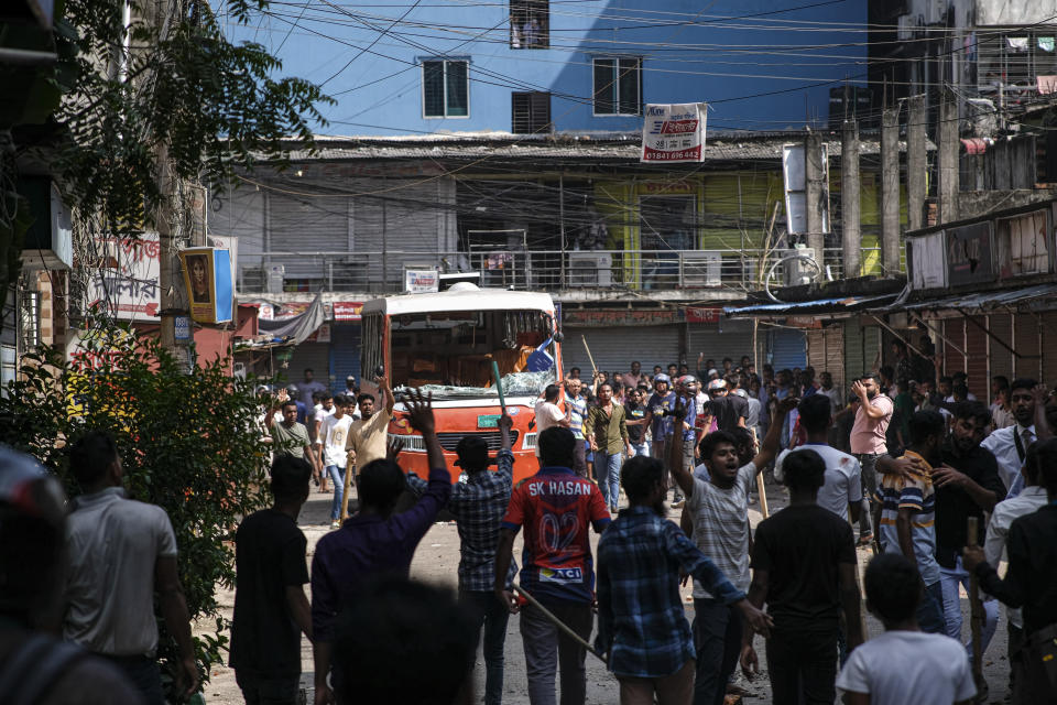 Bangladeshi garment workers vandalize buses during a protest demanding an increase in their wages at Mirpur in Dhaka, Bangladesh, Tuesday, Oct.31, 2023. (AP Photo/Mahmud Hossain Opu)