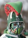 A Saskatchewan Roughrider fan gets ready outside the stadium for the 101st Grey Cup game between the Saskatchewan Roughriders and the Hamilton Tiger Cats in Regina, Saskatchewan November 24, 2013. REUTERS/Todd Korol (CANADA - Tags: SPORT FOOTBALL)