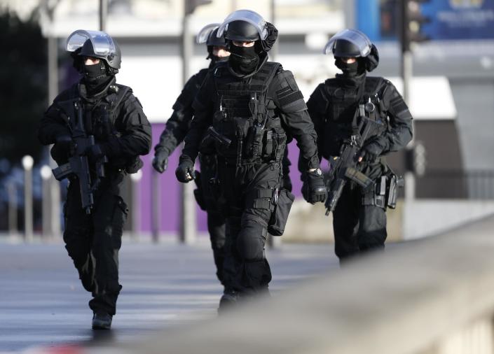 Members of the French police walk above the "peripherique" (circular road) in Paris, take their positions a kosher grocery store, on January 9, 2015 (AFP Photo/Thomas Samson)