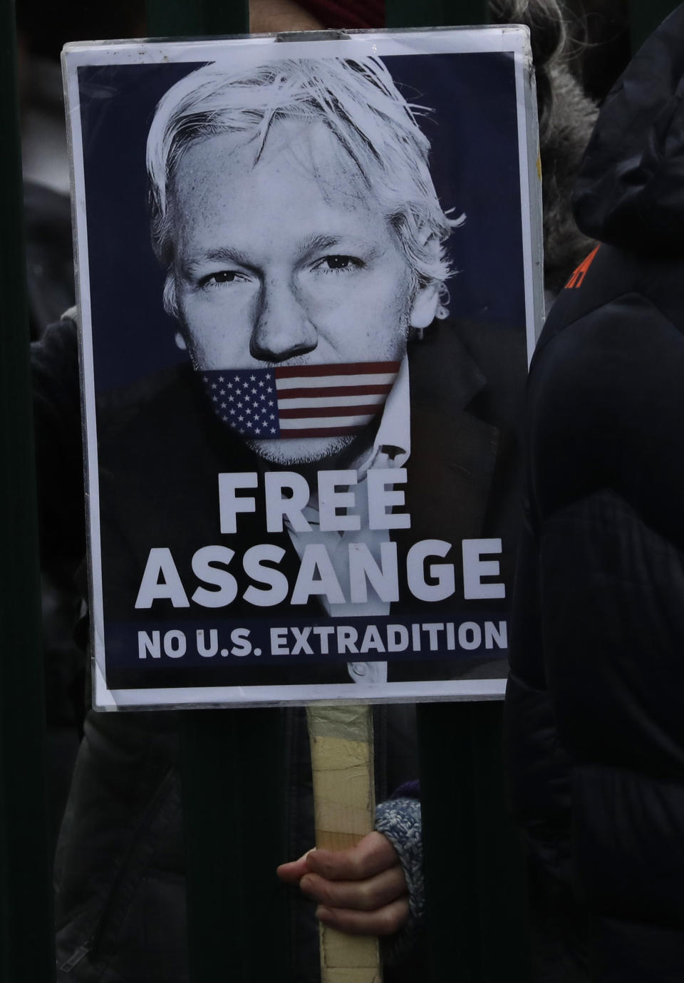 A supporter hold a placard which reads 'Free Assange' as she protests against the extradition of Wikileaks founder Julian Assange outside Belmarsh Magistrates Court in London, Monday, Feb. 24, 2020. The U.S. government and WikiLeaks founder Julian Assange will face off Monday in a high-security London courthouse, a decade after WikiLeaks infuriated American officials by publishing a trove of classified military documents. (AP Photo/Matt Dunham)