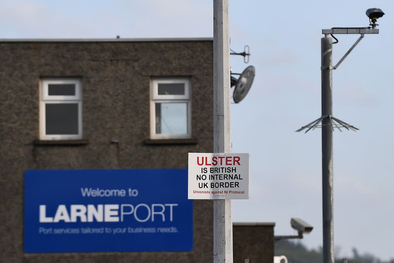 A sign is seen with a message against the Brexit border checks in relation to the Northern Ireland protocol at the harbour in Larne