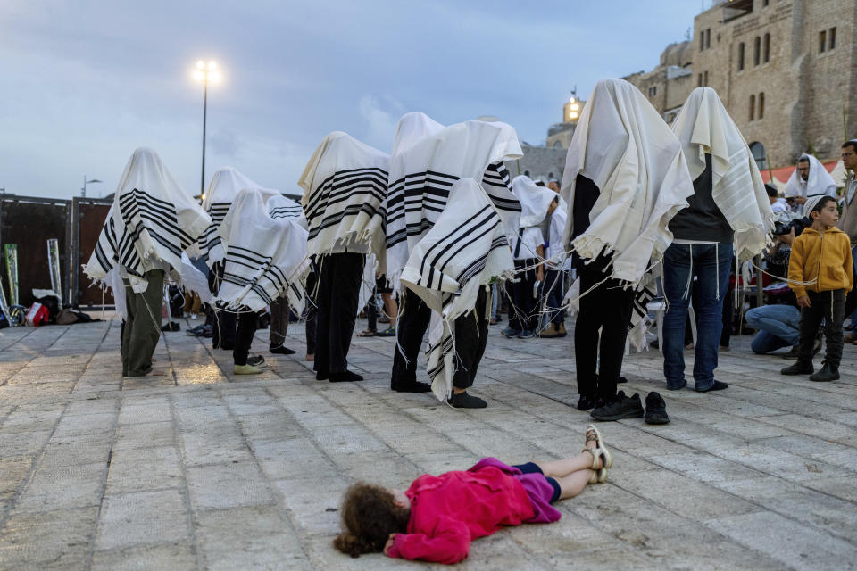 Covered in prayer shawls, Jewish men take part in priestly blessing during the weeklong holiday of Sukkot in front of the Western Wall, the holiest site where Jews can pray in Jerusalem's Old City, Monday, Oct. 2, 2023. (AP Photo/Ohad Zwigenberg)