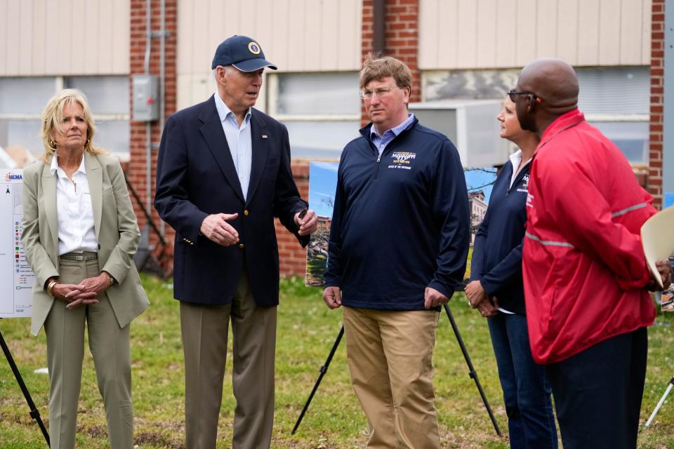 First lady Jill Biden, left, listens as President Joe Biden speaks during a briefing in Rolling Fork on Friday. Mississippi Gov. Tate Reeves, third from right, his wife Elee Reeves and Rolling Fork Mayor Eldridge Walker, right, look on. The President traveled to Rolling Fork to survey the damage after a deadly tornado and severe storm moved through the area.