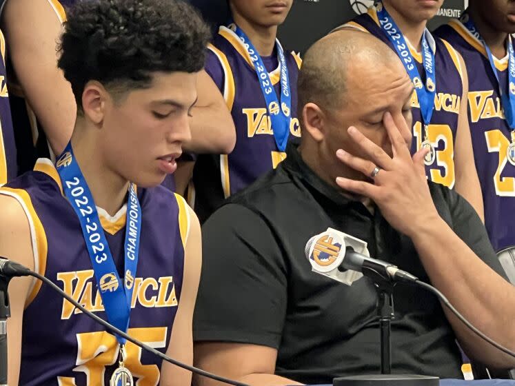 Valencia coach Bill Bedgood wipes away a tear