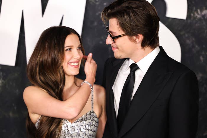 millie and jake looking and smiling at each other during an event