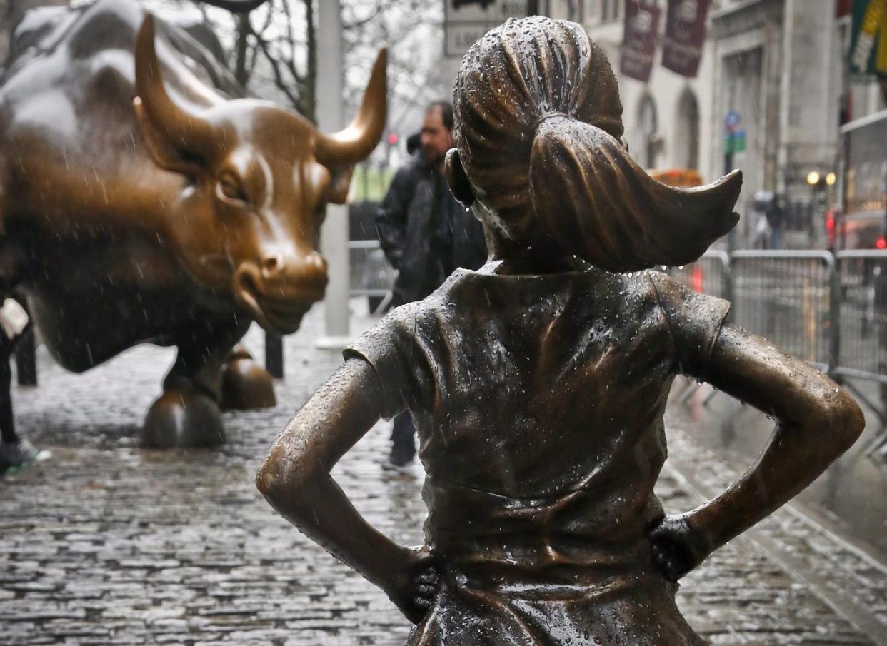 <span class="caption">The Fearless Girl statue stands across from the Charging Bull statue in New York's financial district. </span> <span class="attribution"><span class="source">(AP Photo/Bebeto Matthews)</span></span>